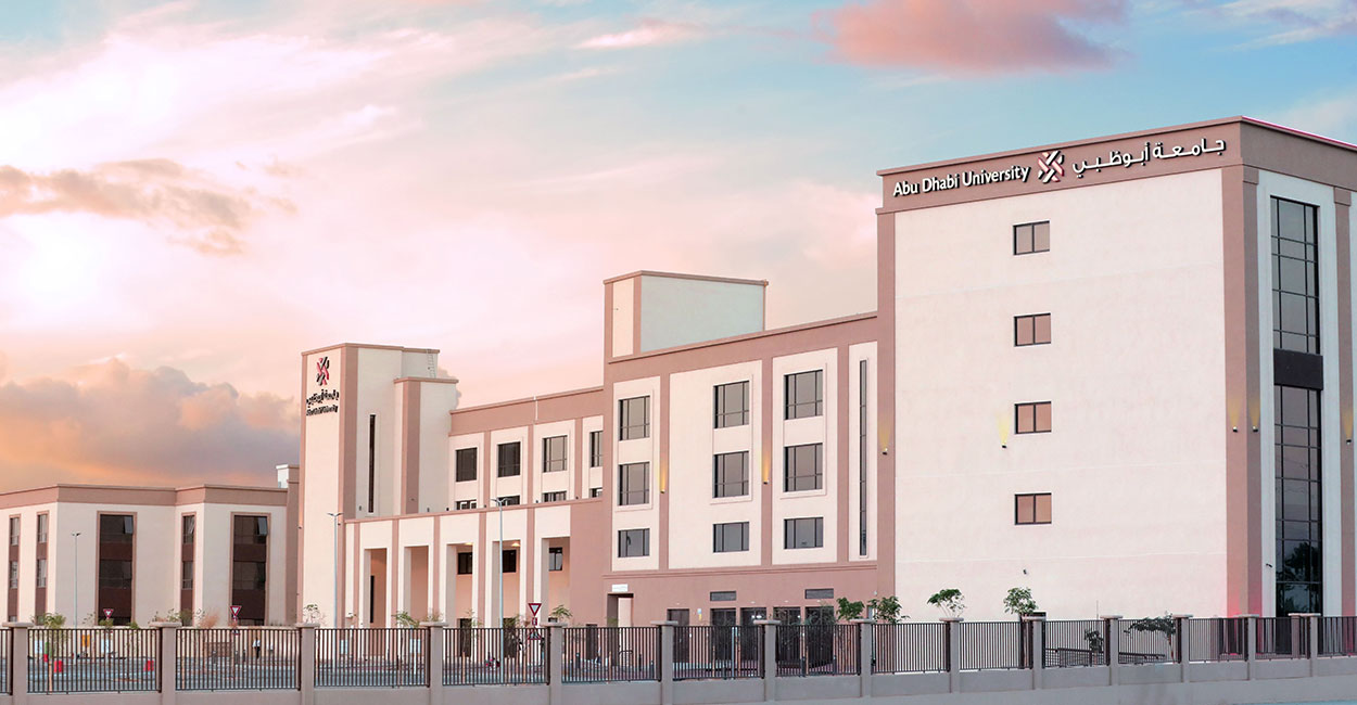Abu Dhabi University Al Ain campus building with modern architecture and palm trees.