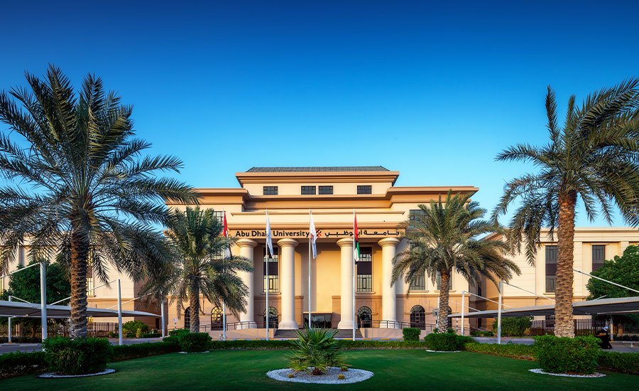 Main campus of Abu Dhabi University featuring modern architecture and palm trees.