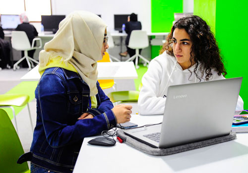 Female students working on an undergraduate business assignment